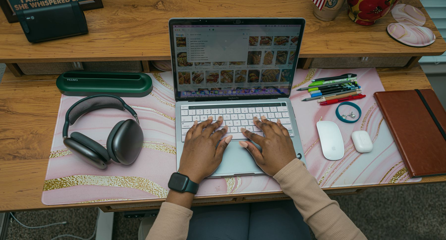 Hands typing on a laptop keyboard.